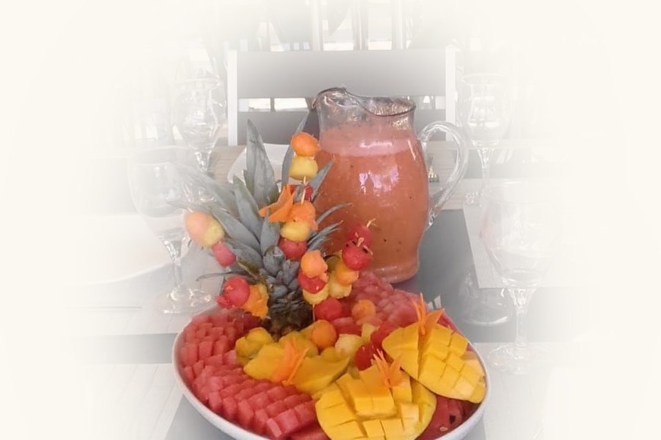 A fruit platter and a jug of fresh juice, set out for a celebration