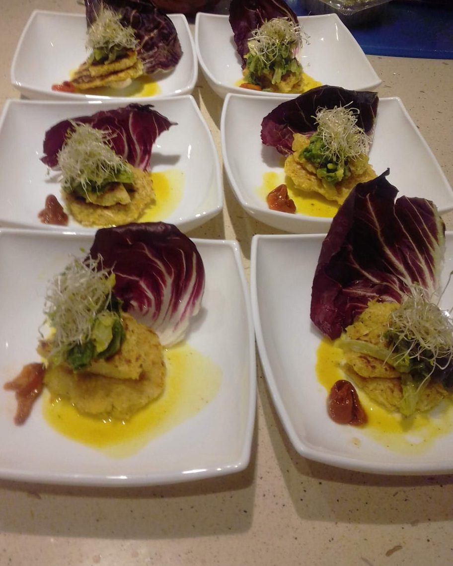 Corn cakes with radicchio and sprouts, plated for a table of six
