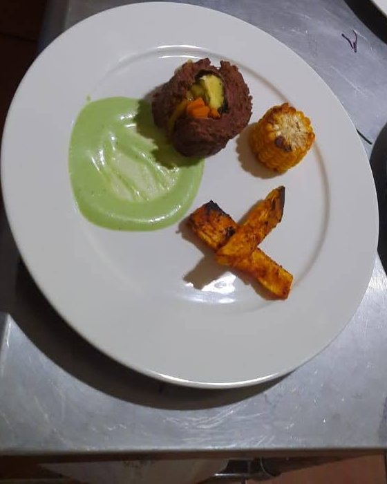Plates being finished on the pass during a dinner service